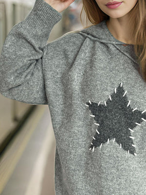 Gray knit hoodie with textured star appliqué detail and white stitching.