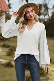 White waffle knit raglan sweater with laser cut sleeves and V-neck