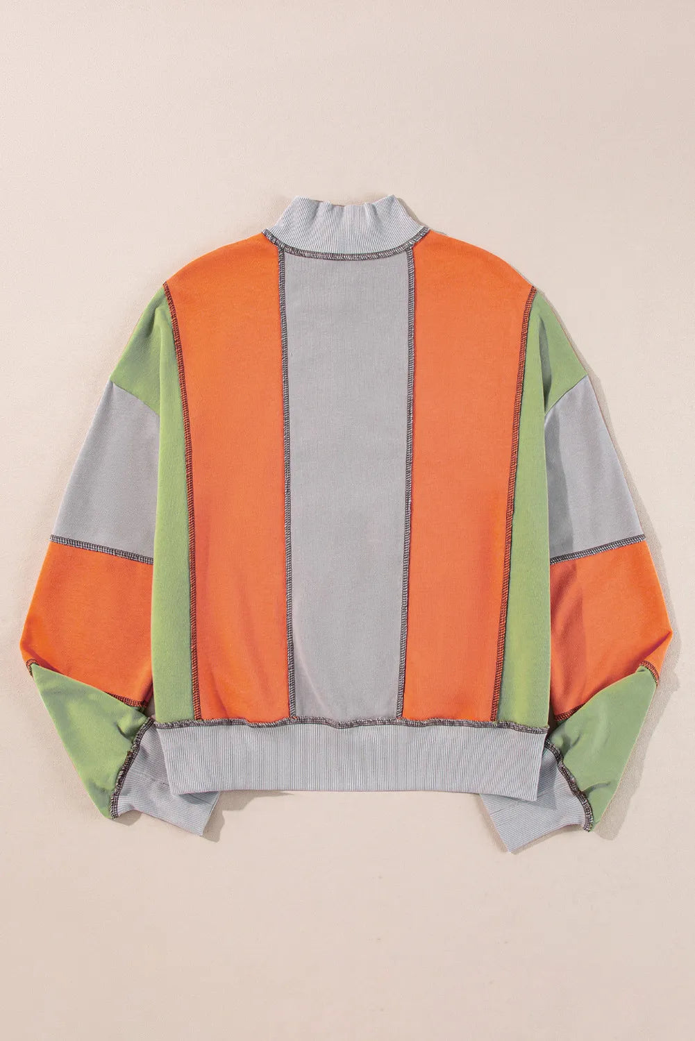 Colorblock sweatshirt with contrast stitching and mock neck.