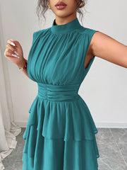 Sleeveless teal ruffled tiered dress with ruched waist and mock neck.
