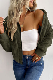 Green teddy fleece bomber jacket with collared neck and zip front, styled with a white tube top and jeans.
