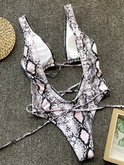 Snakeskin print one-piece swimsuit with plunging neckline and crisscross back straps