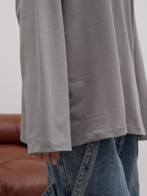 Light gray oversized crewneck sweatshirt with voluminous sleeves and crew neckline.