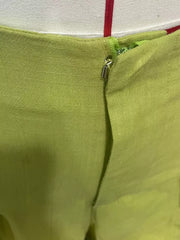Sophisticated high-waist flowing pants in lime green with a zipper detail.