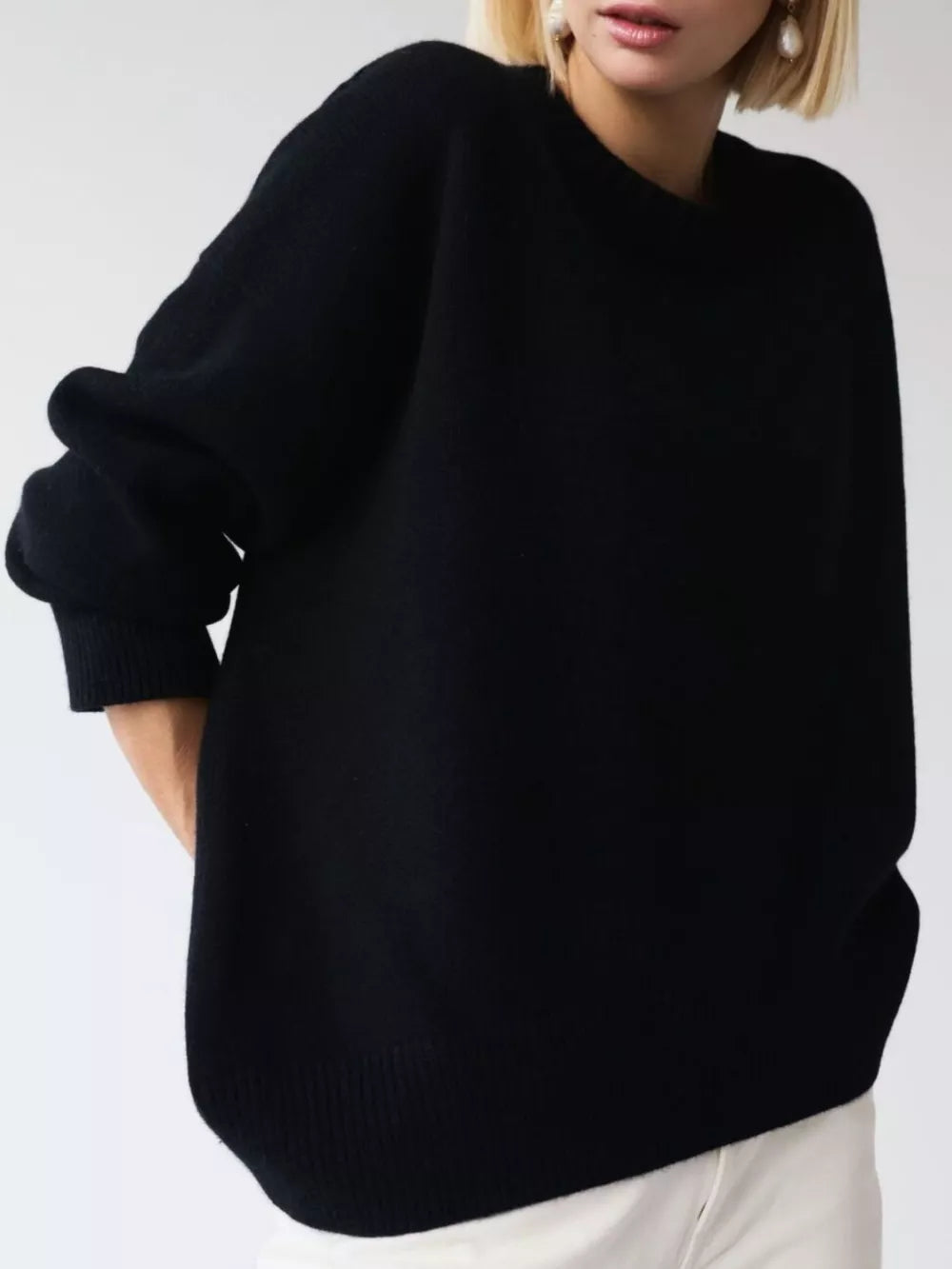 Black soft knit sweater with ribbed detailing and crew neck.
