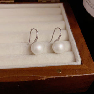 Silver freshwater pearl drop earrings with simple hooks.