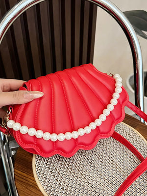 Red shell crossbody bag with pearl embellishment and quilted detail