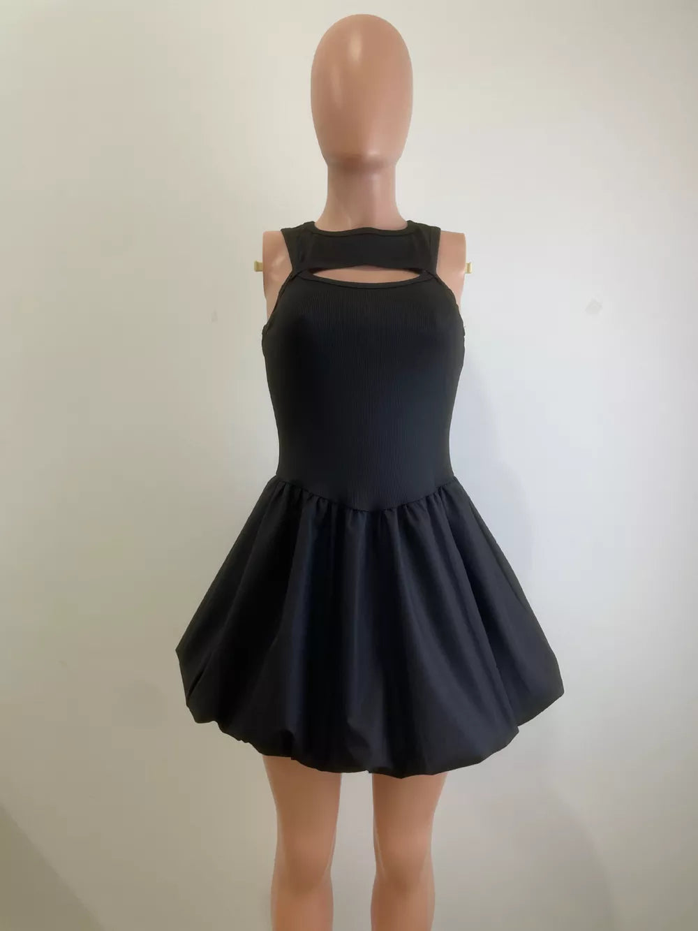 Black cutout mini dress with bubble hem and ribbed bodice