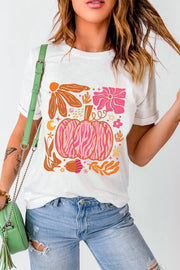 White crewneck tee with a colorful autumnal graphic featuring a pink zebra-striped pumpkin and floral elements.