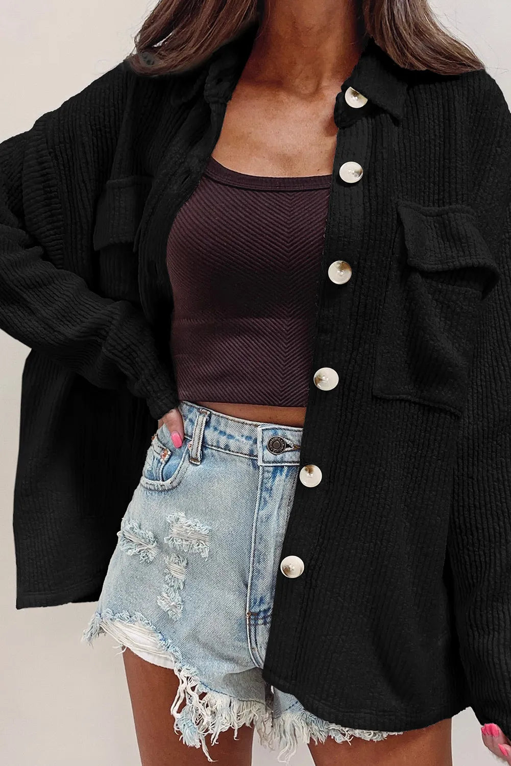 Black textured corduroy overshirt with patch pockets and button front.