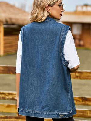 Sleeveless denim utility vest in medium wash with button detail and collar.