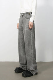 Wide-leg dark gray washed denim jeans with a belt and a relaxed fit.