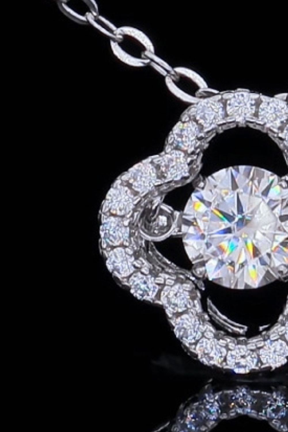 Silver pendant necklace with clover cut moissanite and diamond accents.