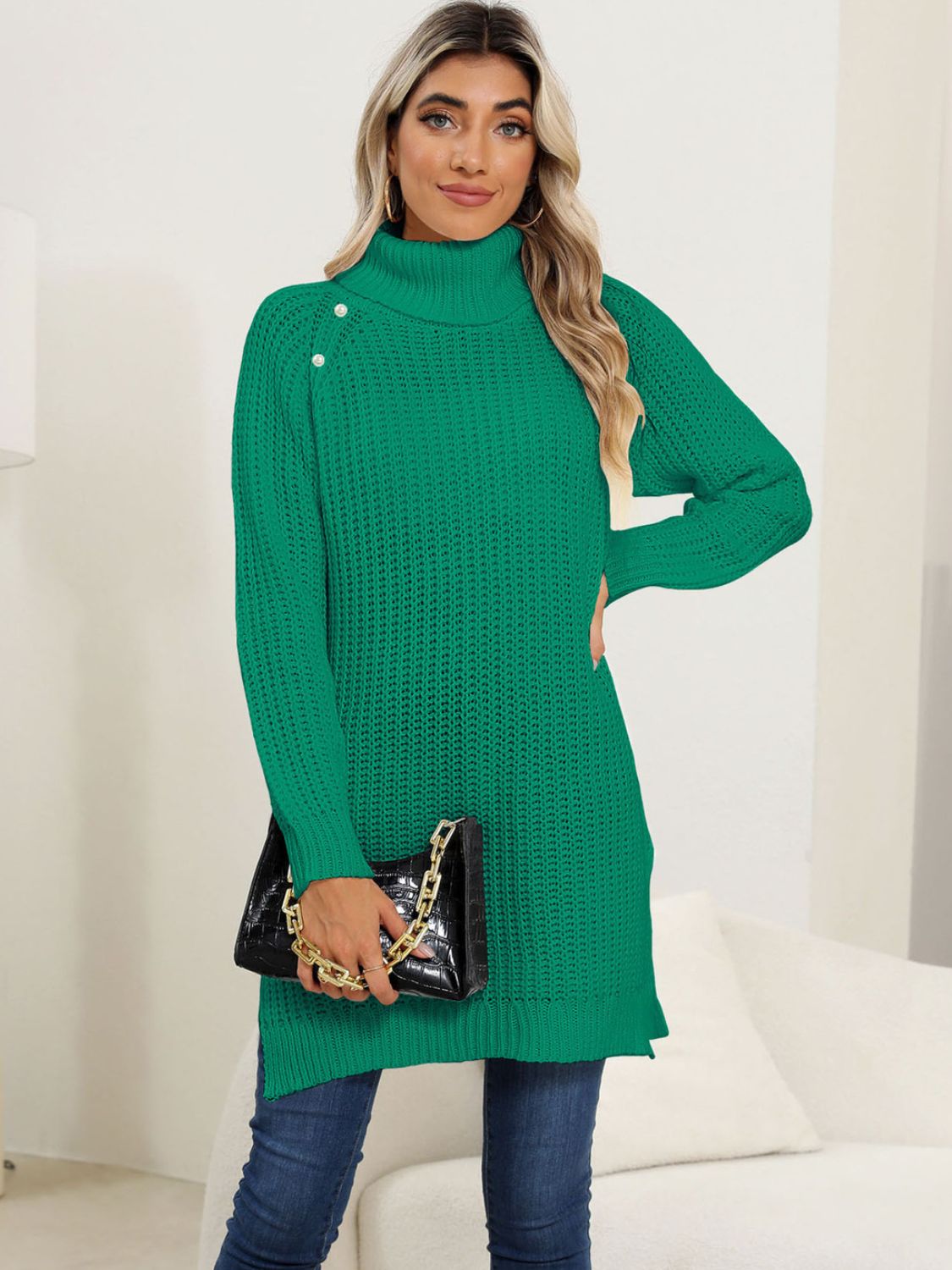 Green ribbed turtleneck tunic with pearl buttons on the shoulder, long sleeves, and side slits.