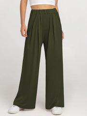 Army green pleated palazzo trousers with pockets and elastic waist.