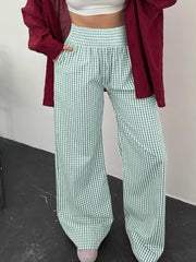 Smocked high-waist wide-leg pants in green gingham with a relaxed fit.