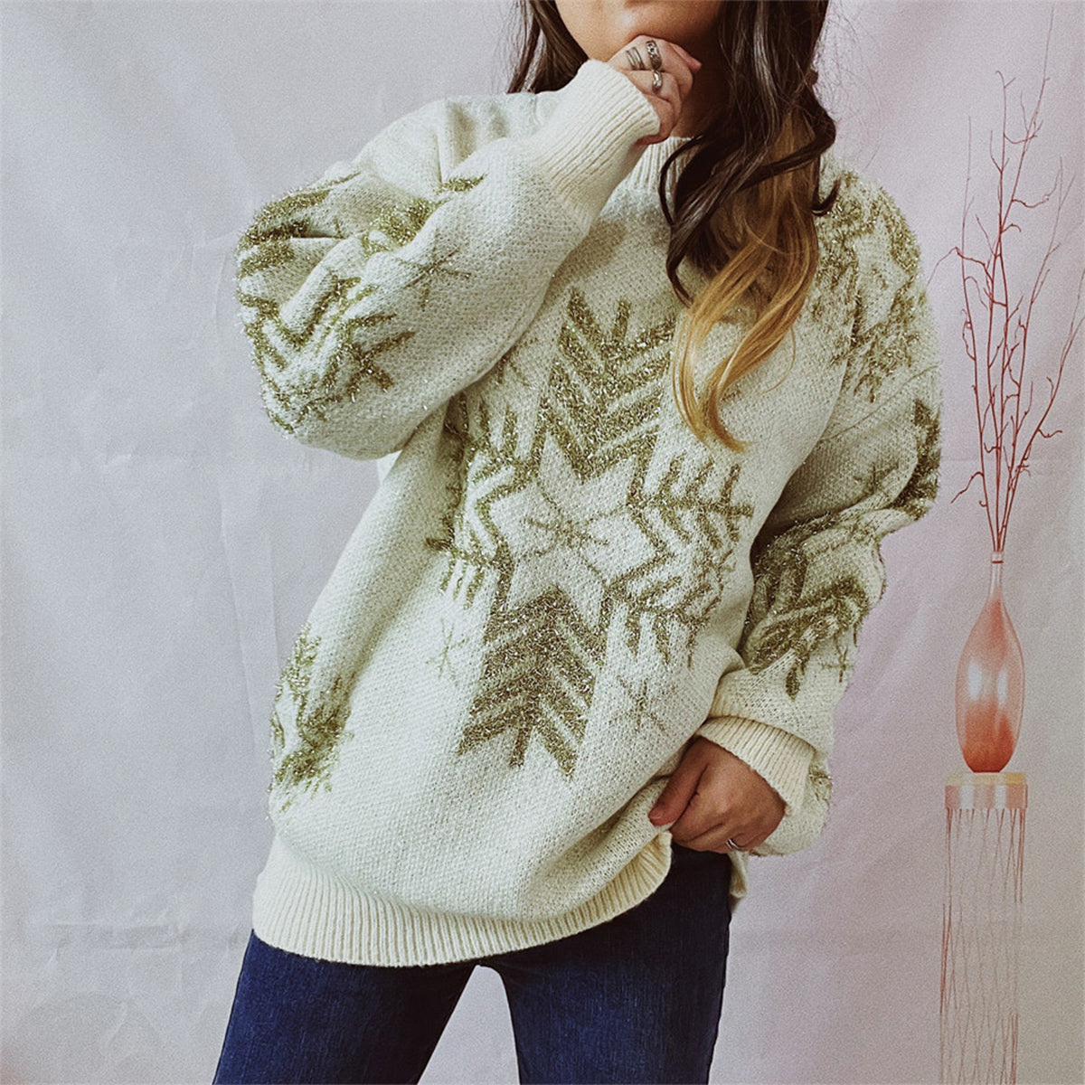 Cream acrylic knit sweater with gold snowflake embellishments and crew neck.