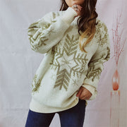Cream acrylic knit sweater with gold snowflake embellishments and crew neck.