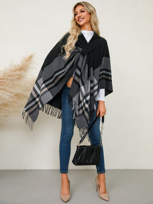 Black asymmetric plaid fringe cape with a V-neck and tie detail.