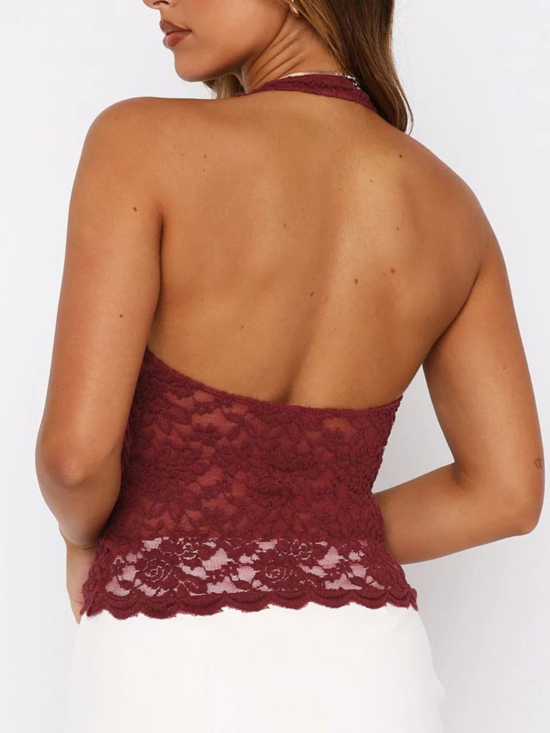 Burgundy floral lace halter top with a backless design and scalloped hem.