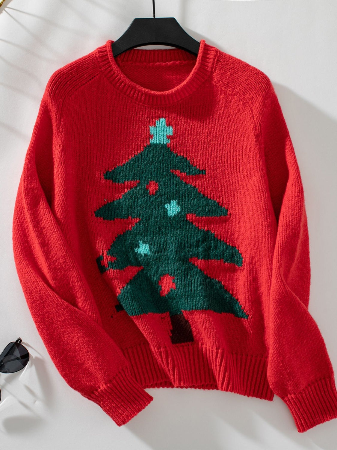 Red acrylic knit sweater with intarsia Christmas tree pattern and crew neck.