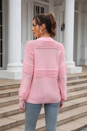 Openwork ribbed knit sweater in blush pink with horizontal openwork details on the yoke and sleeves.