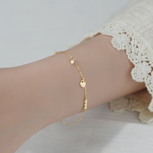 Gold pavé heart charm bracelet with delicate chain and cubic zirconia accents.