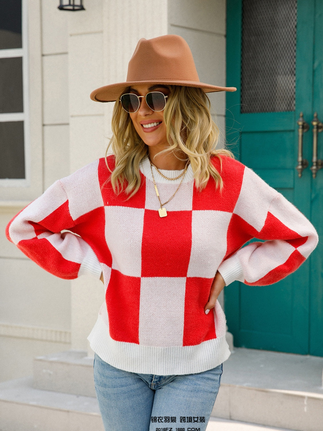 Checkerboard knit pullover sweater in red and white with balloon sleeves.