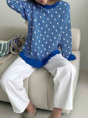 Royal blue knit sweater with allover white sailboat pattern and crewneck.
