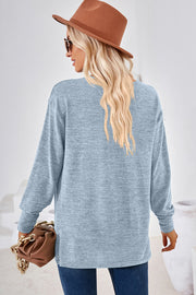 Light blue relaxed V-neck tunic top with long sleeves and heathered texture.