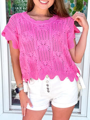 Chic openwork knit sweater vest in bright pink cotton with cable knit pattern and scalloped hem.