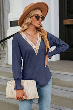 Dark Blue textured V-neck blouse with lace trim and smocked cuffs.