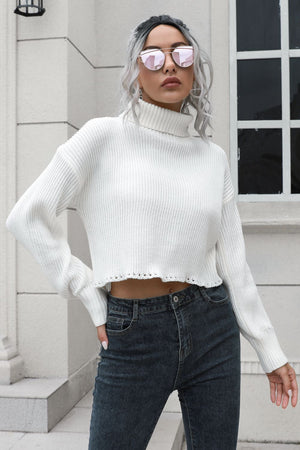White ribbed turtleneck sweater with scalloped hem and long sleeves