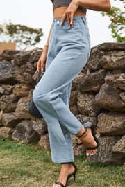 Light wash denim jeans with split hem and straight leg cut.
