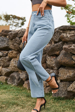 Light wash denim jeans with split hem and straight leg cut.