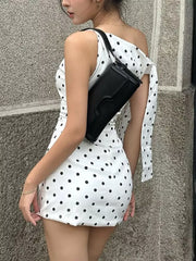 White polka dot mini dress with asymmetrical neckline and bow detail on shoulder.