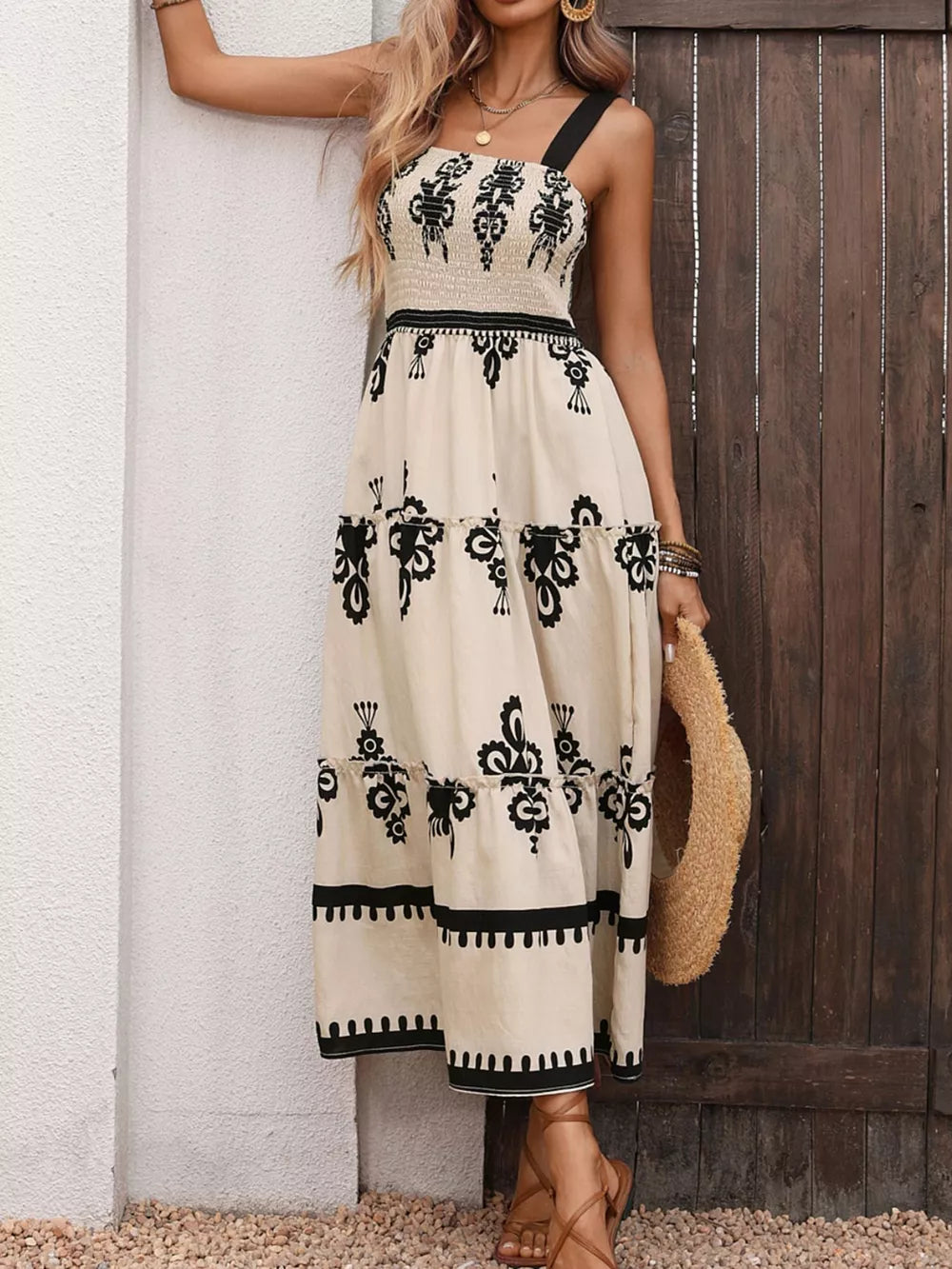 Bohemian smocked maxi dress with tiered skirt, black print on cream, square neck, spaghetti straps.