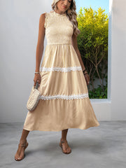 Yellow striped midi dress with smocked bodice, tiered skirt, and lace trim.