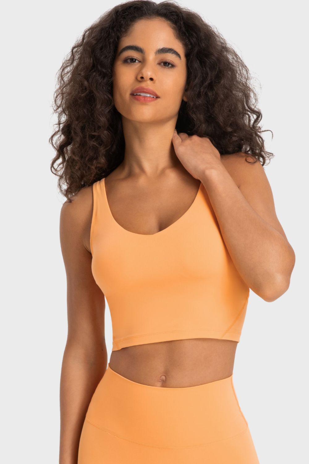 Sculpted Scoop Neck Crop Top in Squash, a sleeveless activewear top with a fitted cut.