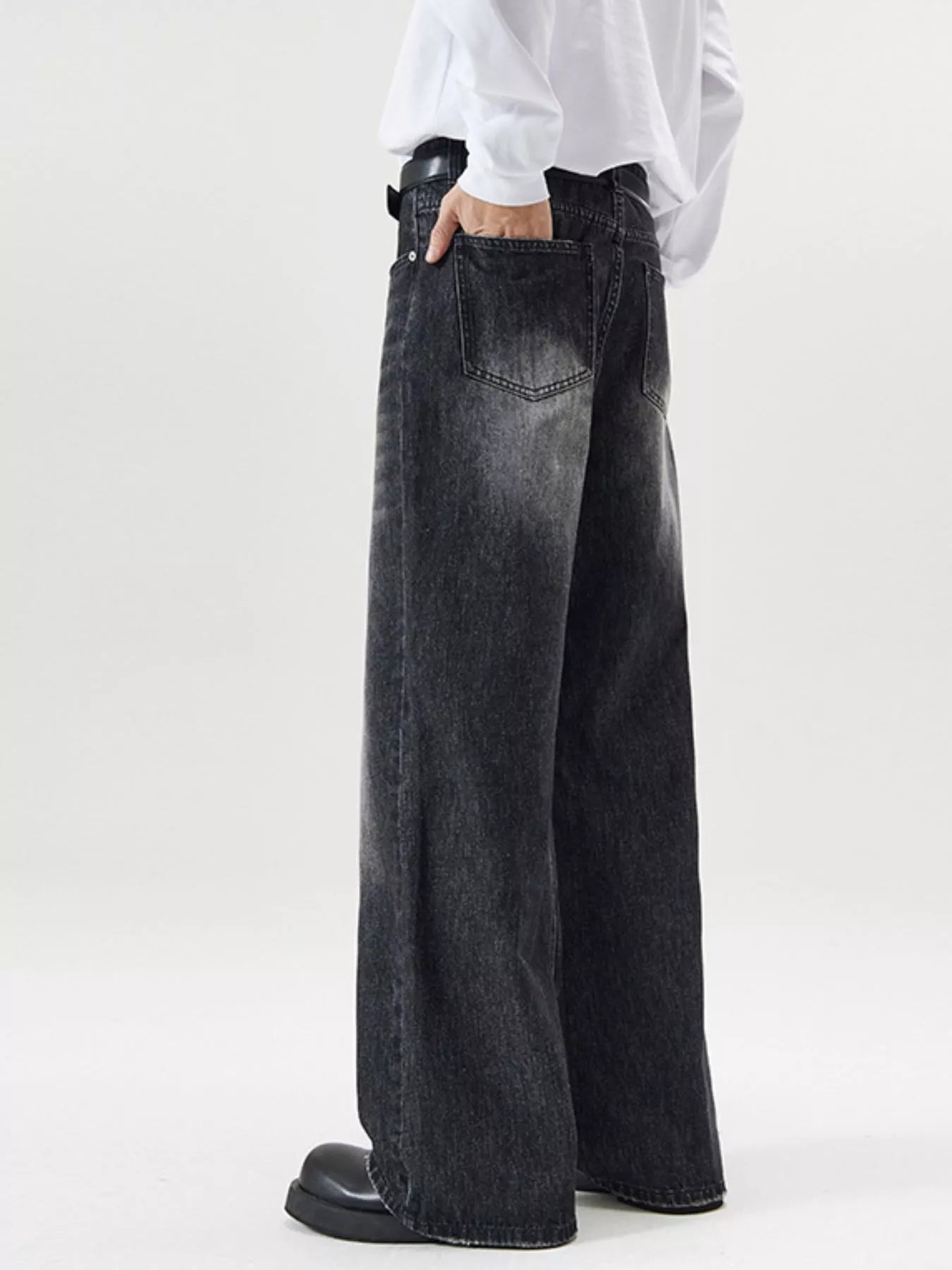 Men's wide-leg wash denim jeans in black with a relaxed fit.