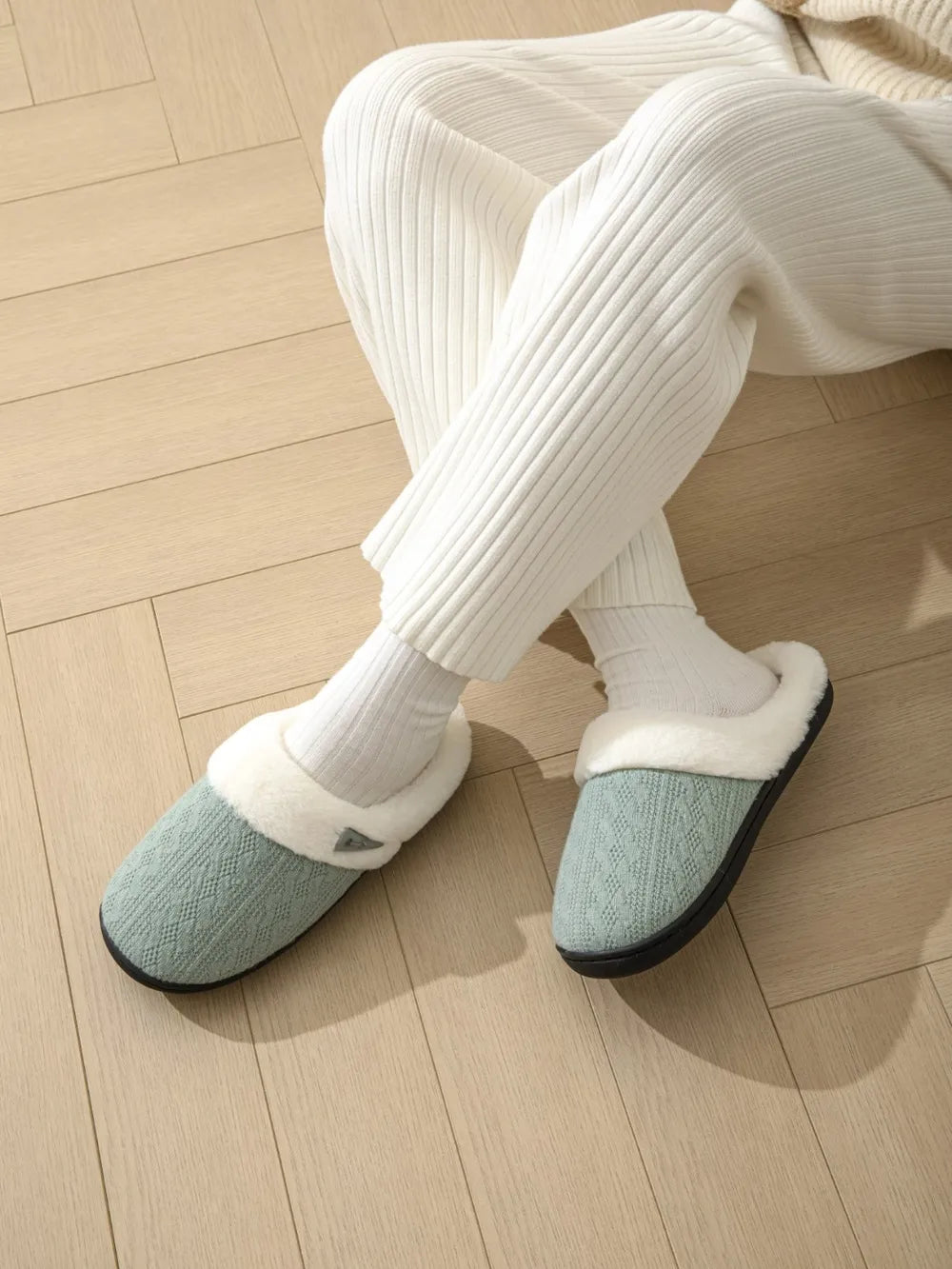 Cable knit shearling house slippers in Dusty Blue with cozy white trim.