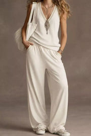 White V-neck tank top and wide-leg pants set with elastic waist and beaded trim.