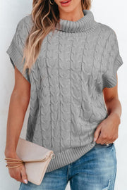 Gray cable knit turtleneck capelet sweater with short sleeves and ribbed trim.