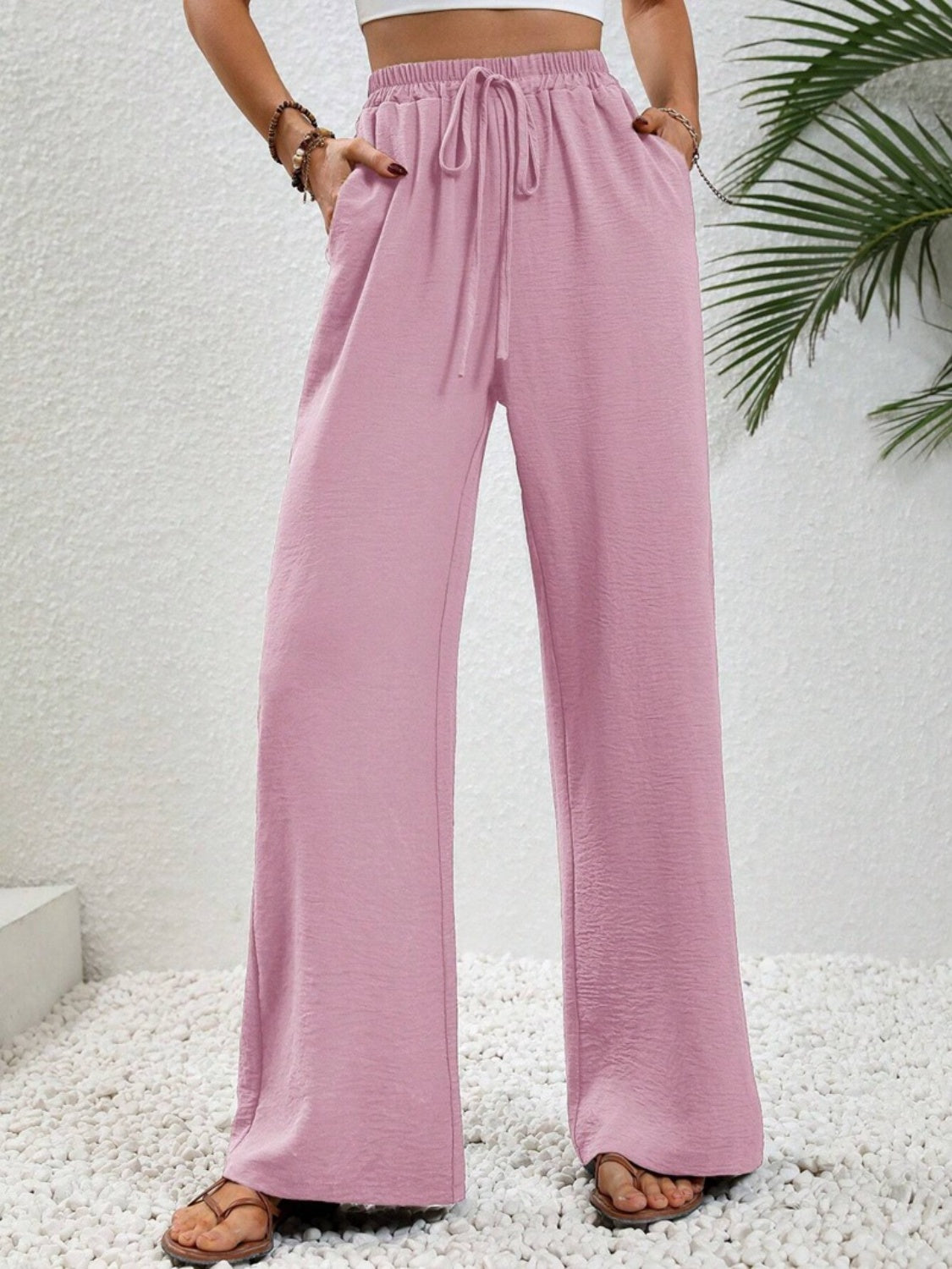 Pink textured palazzo trousers with drawstring waist and pockets