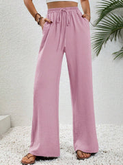 Pink textured palazzo trousers with drawstring waist and pockets