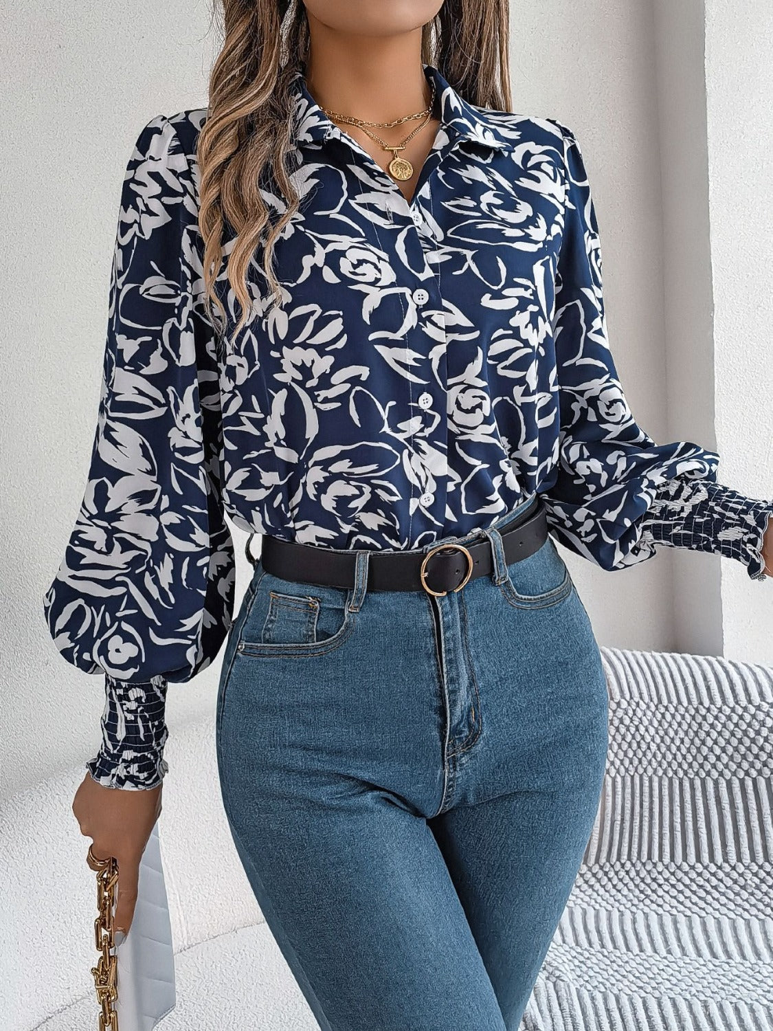 Navy floral print blouse with shirred cuffs and button front