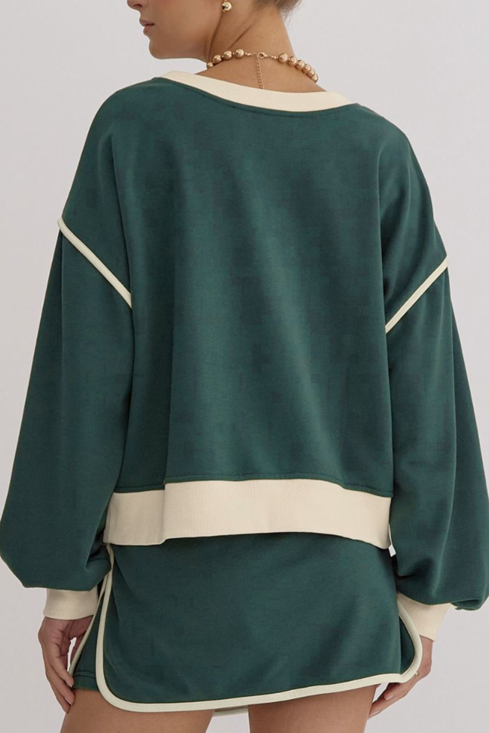 Dark green sweatshirt and skort set with cream contrast trim and neckline.