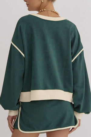 Dark green sweatshirt and skort set with cream contrast trim and neckline.