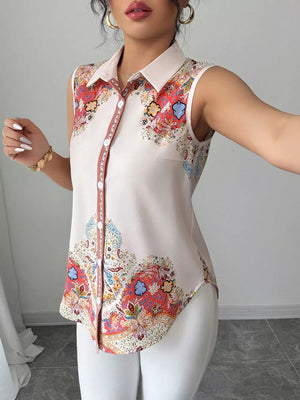 Sleeveless collared shirt in White Flower with vibrant paisley print, button front, and curved hem.