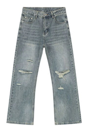 Distressed flare jeans in medium wash denim with raw-cut knee details.